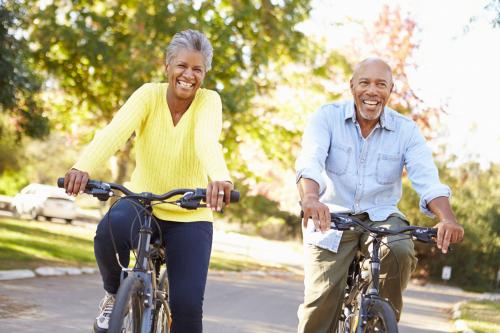 Older couple riding bikes on a sunny day